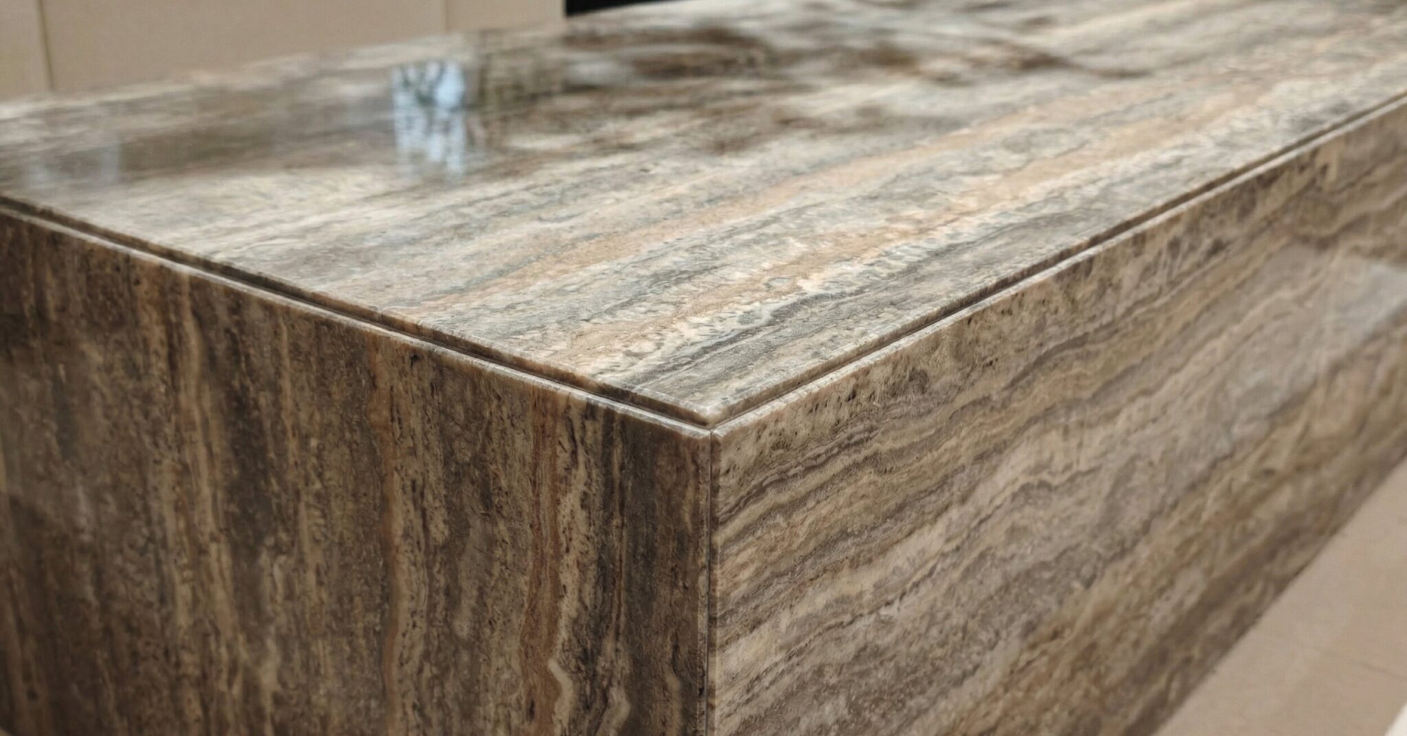 Close-up detail of travertine bench surface and edge in Pune project